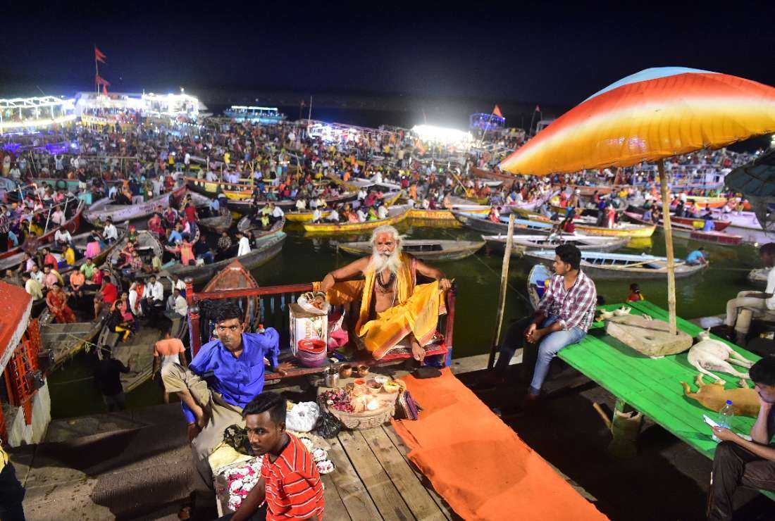 Indian Hindu devotees attend evening prayers on the banks of the river Ganges at Dashashwamedh Ghat in Varanasi, on July 8