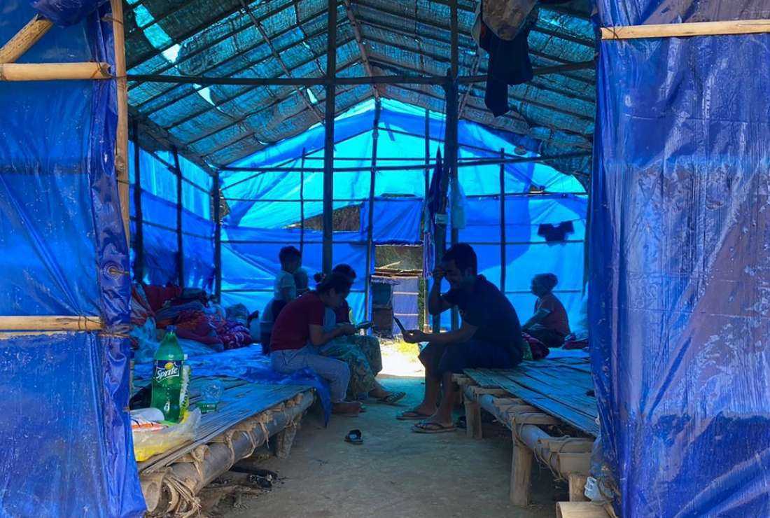Refugees fleeing Myanmar rest in a basic shelter at the Farkwan quarantine camp in the eastern state of Mizoram, India, near the Myanmar border on September 23, 2021, after they were attacked by Myanmar's military on villages in the western Chin state border. had fled across.