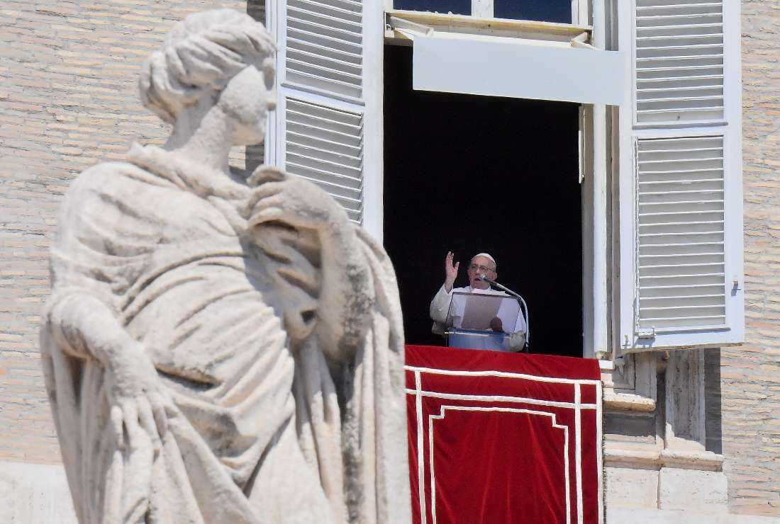 Pope Francis speaks from the window of the apostolic palace during the weekly Angelus prayer in the Vatican on Aug. 14