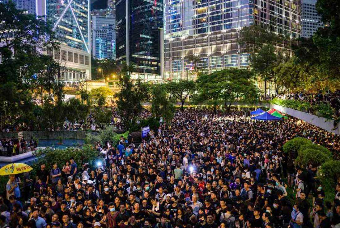 This file photo shows people attending a protest held by civil servants in the Central District of Hong Kong on August 2, 2019, against a planned extradition law. The protest quickly evolved into a wider movement for democratic reforms