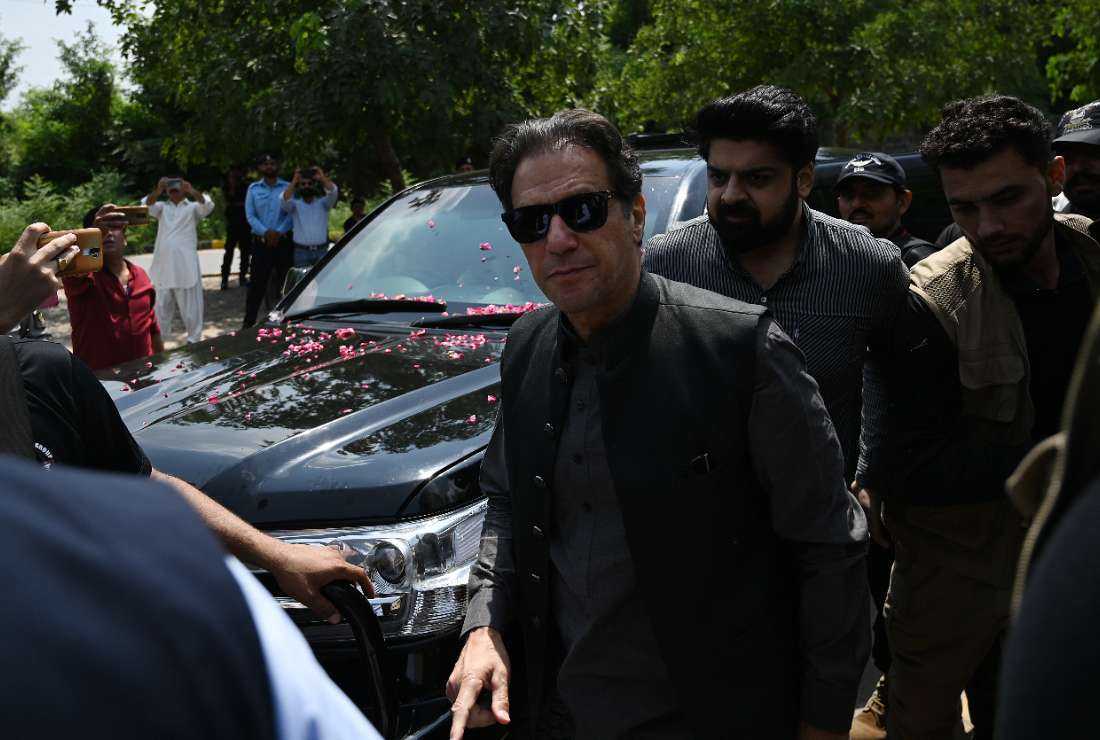 Members of security personnel escort former Pakistani prime minister Imran Khan as he arrives to appear before the Anti-Terrorism Court in Islamabad on Sept. 1