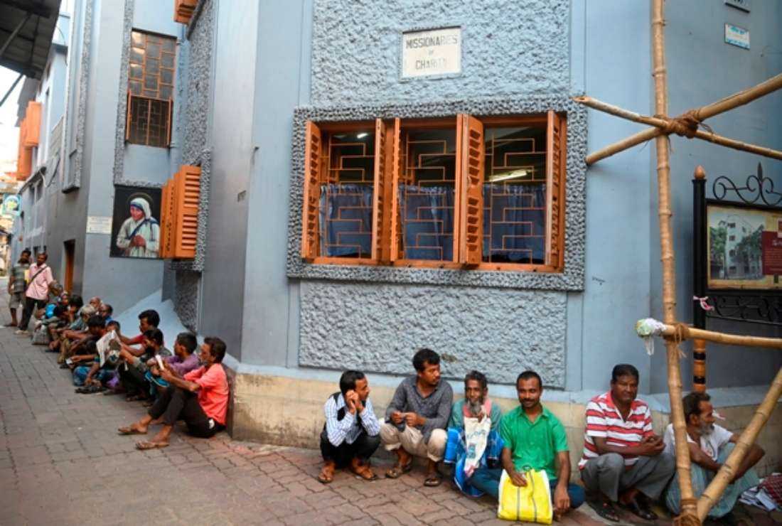People wait during a special prayer on the occasion of “Peace Day“ to mark the death anniversary of Mother Teresa at the Mother House in Kolkata, India, on Sept. 5
