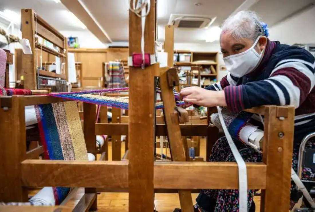 Kimiko Osawa makes crafts for a welfare trade shop in Hachioji in Tokyo that sells items made by hand by people with various disabilities across Japan