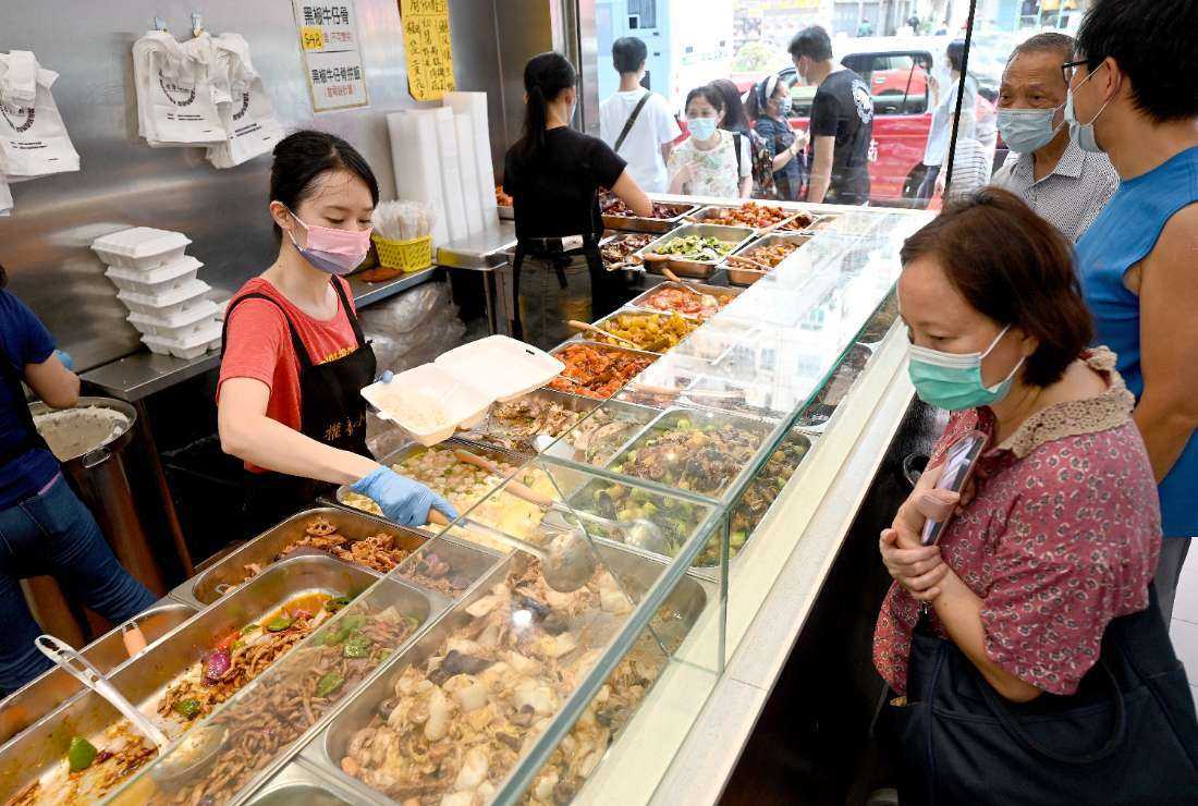 Customers being served low-priced two-dish meal boxes at Kitty Chan's restaurant in Hong Kong on Sept. 18