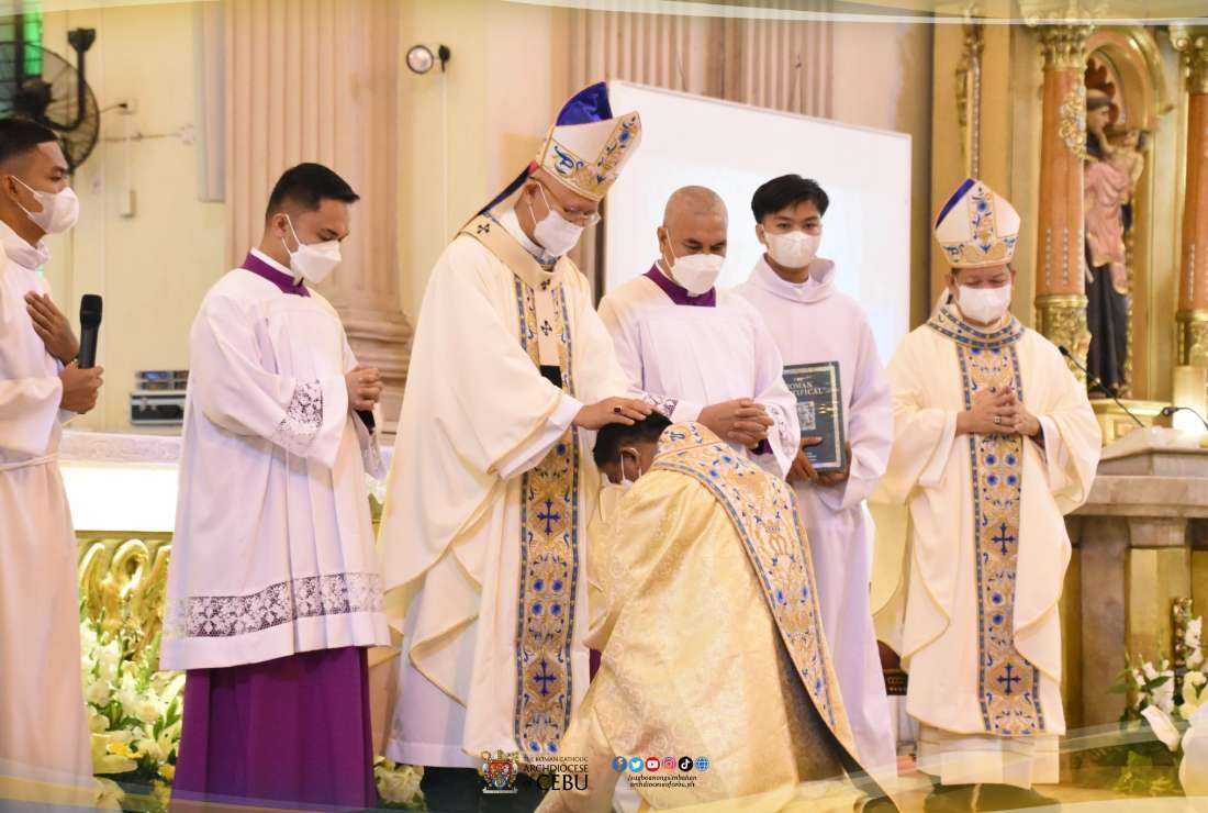 Archbishop Jose Palma of Cebu lays down his hands over the newly ordained Auxiliary Bishop of Cebu Ruben Labajo, in Cebu City