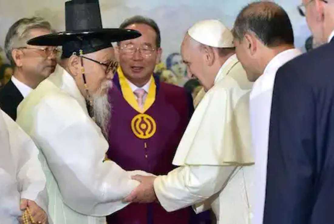Pope Francis greets Han Yang-Won, chairman of the Association for Korean Native Religion, and other religious leaders at Myeongdong Cathedral in Seoul in 2014