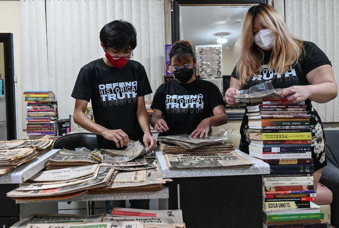 Project Gunita members arranging period publications from the Philippines' martial law era to be archived, in Taguig, suburban Manila