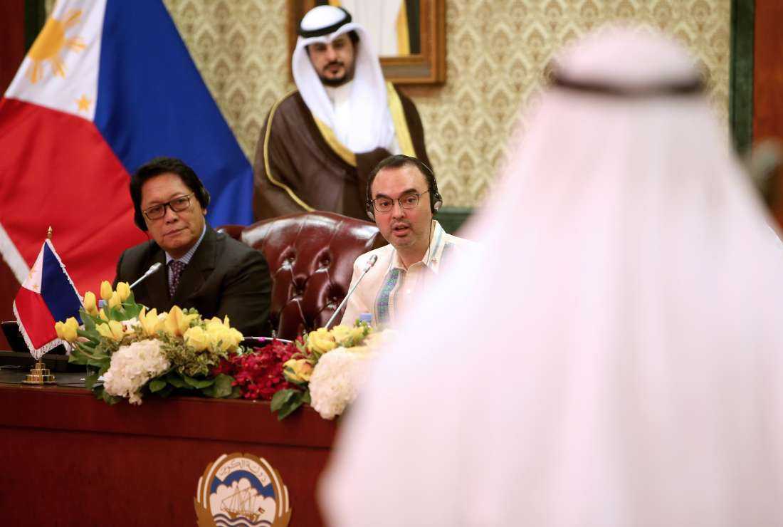 Philippino secretary of labor Silvestre Bello (first from left) and Philippino foreign affairs secretary Alan Peter Cayetano (second from left) hold a press conference after signing an agreement to regulate domestic workers, at Kuwait's foreign ministry in Kuwait City on May 11, 2018