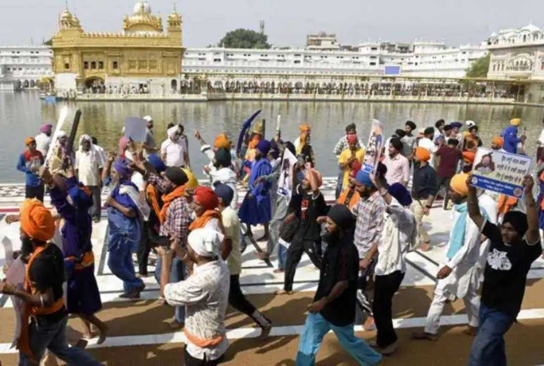 Activists from Sikh organizations shout slogans after offering prayers at the Golden Temple on the 38th anniversary of Operation Blue Star in Amritsar on June 6