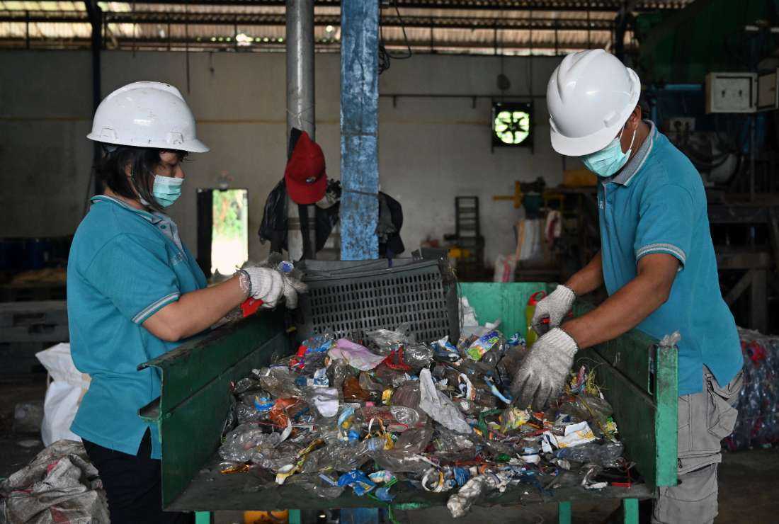 Workers sorting plastic mineral water bottles at a plastics recycling factory in Tangerang, Banten province of Indonesia on Aug. 5