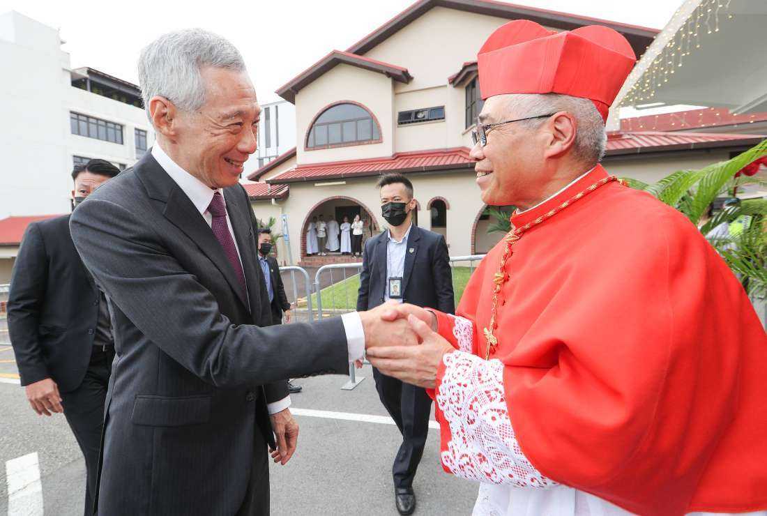 Singapore's Prime Minister Lee Hsien Loong greets Cardinal William Goh