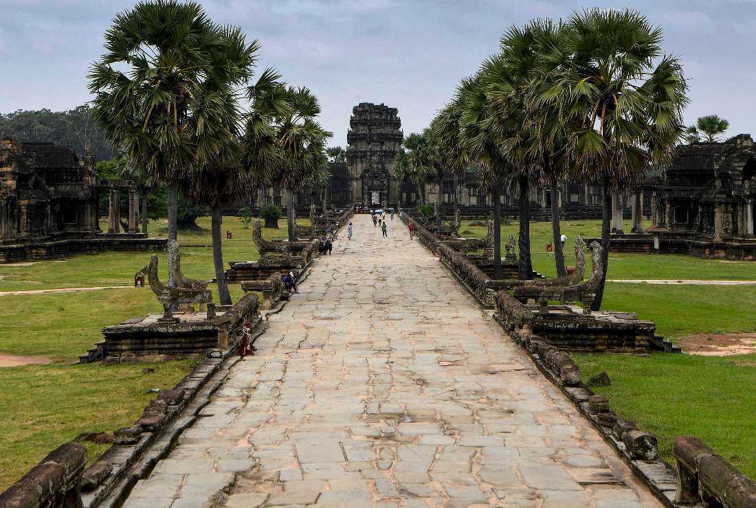 This photo taken on October 12, 2020, shows tourists visiting the Angkor Wat temple in Siem Reap province, where a few hundred cult followers have now taken refuge on a remote farm after prophecies that doomsday floods would occur by Aug. 31