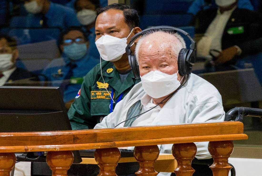 This handout photo taken and released by the Extraordinary Chamber in the Courts of Cambodia (ECCC) on September 22, 2022 shows ex-Khmer Rouge head of state Khieu Samphan (R) sits in the court room at the Extraordinary Chamber in the Courts of Cambodia (ECCC) in Phnom Penh