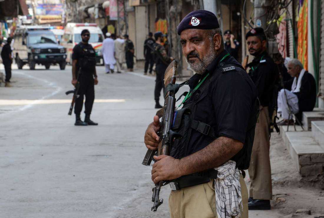 Pakistani police stand guard ahead of a Muharram procession in Peshawar on Aug. 7. The police are notorious for inhuman torture and custodial deaths are common in the nation