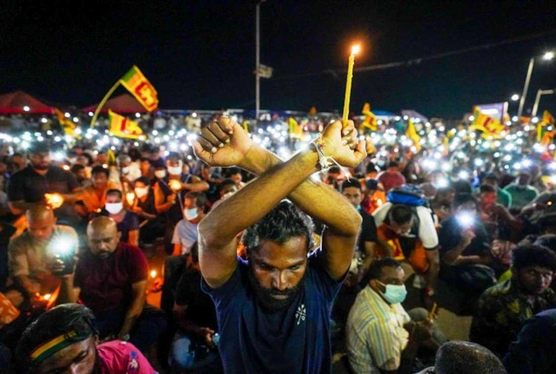 Demonstrators light candles and flash mobile phone lights during a silent protest to pay respect to the victims of the 2019 Easter Sunday suicide bombings on the third anniversary of the attacks near the president's office in Colombo on April 21
