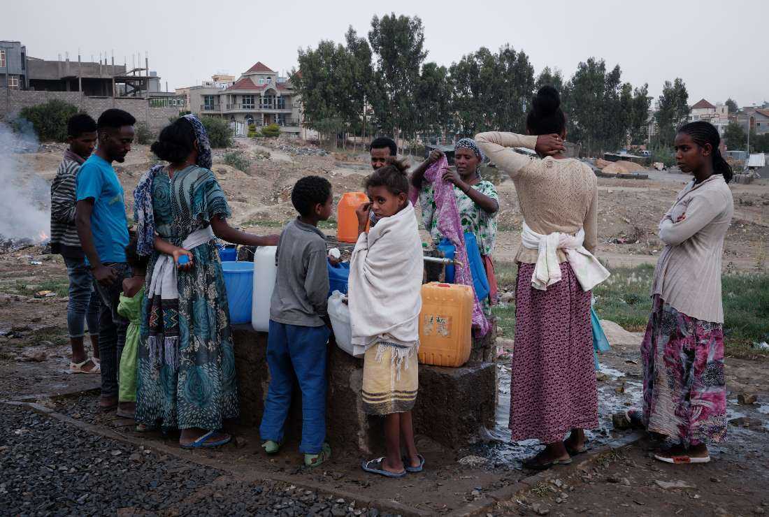 People, who fled the violence in Ethiopia's Tigray region, fetch water at May Weyni secondary school, which has been turned into an Internal Displaced People (IDP) camp registering 10,500 people, in Mekele, the capital of Tigray region, Ethiopia, on June 23, 2021