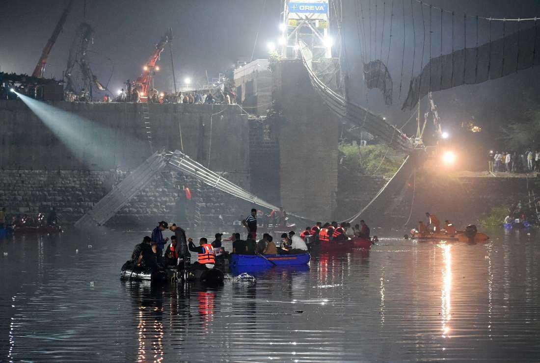 Indian rescue personnel conduct search operations after a bridge across the river Machchhu collapsed in Morbi, some 220 km from Ahmedabad, Gujarat state, on Oct. 30