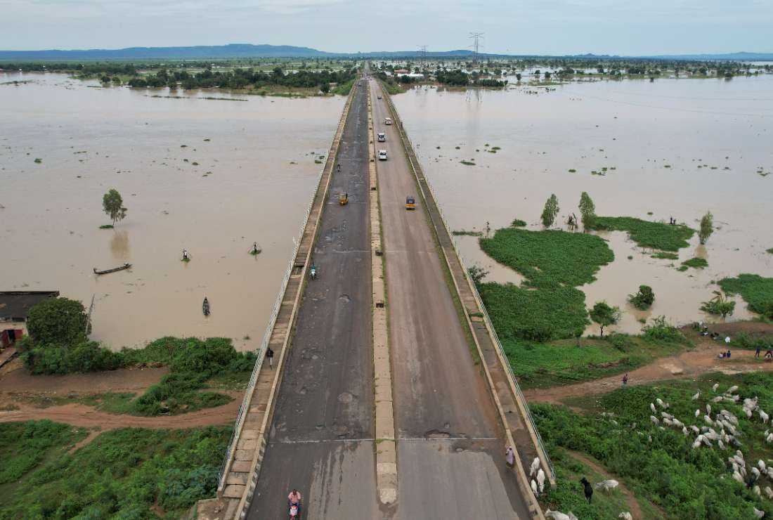 This aerial view shows local residents crossing the Numan bridge while driving to safer grounds away from the rising waters in Numan Community of Adamawa State - North East Nigeria on Sept. 25