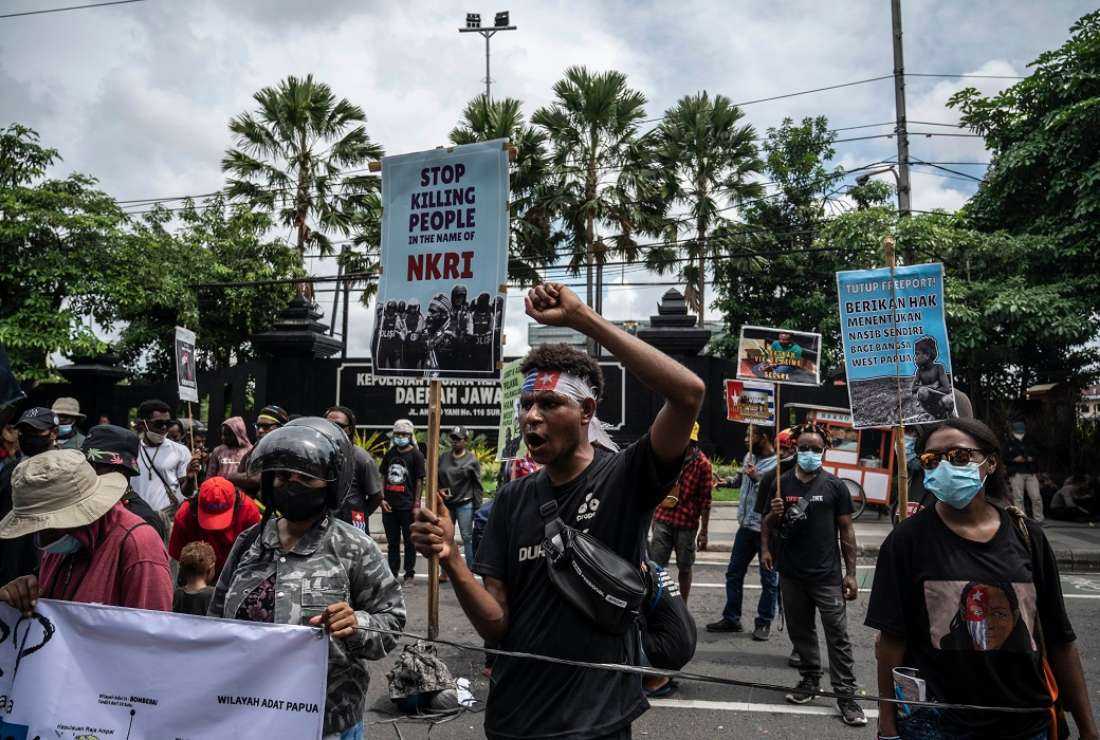 Papuan students hold a protest against the Indonesian government's plan to develop new administrative areas in the country's easternmost Papua province, in Surabaya on May 10