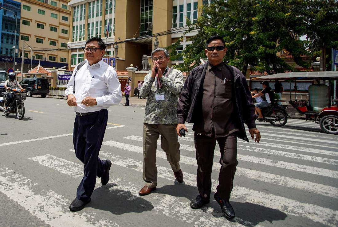 Son Chhay (left), vice president of Candlelight Party and prominent Cambodian opposition politician, walks out of Phnom Penh Municipal after hearing the verdict convicting him of defamation for criticizing the country's June local elections, on Oct. 7