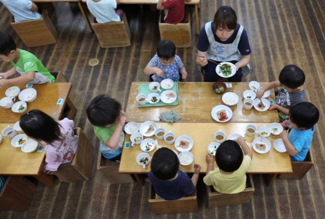 Young children eating lunch at an official nursery school in Yokohama in Japan on June 29, 2016
