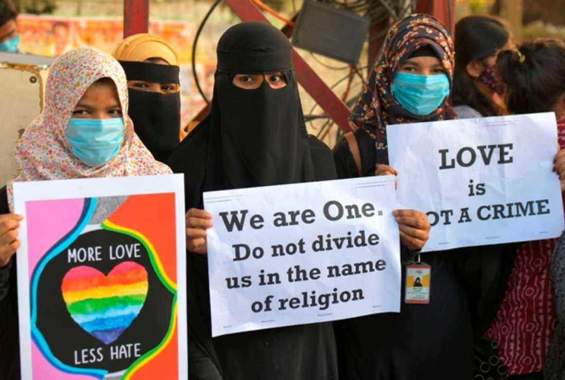 Indian activists hold placards during a demonstration condemning the decision of various Bharatiya Janata Party-led state governments in the country for passing laws against the so-called 'Love Jihad,' in Bangalore on Dec. 1, 2020