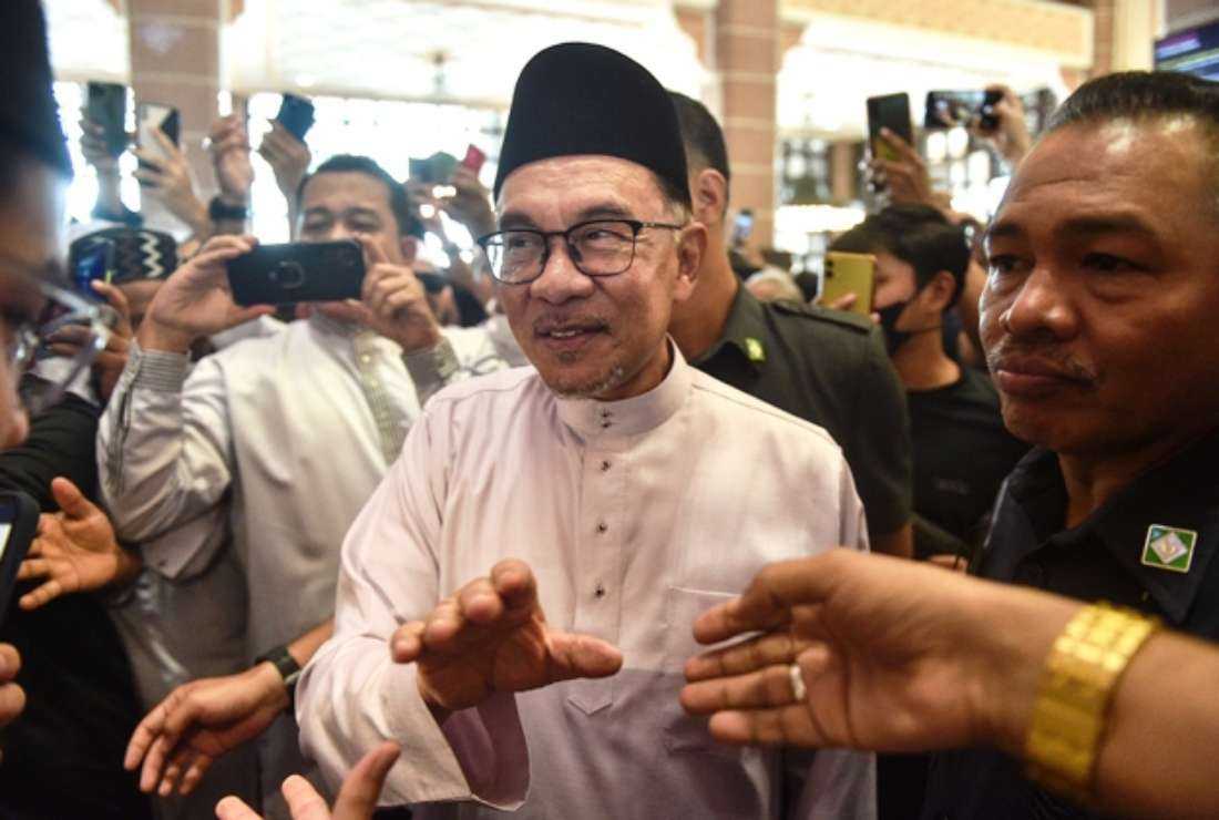 Malaysia's Prime Minister Anwar Ibrahim greets people as he leaves Putra Mosque after prayers in Putrajaya, on Nov. 25