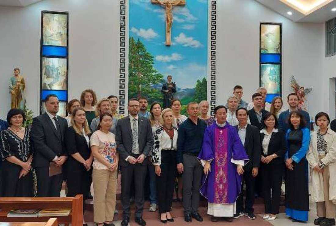 Father Vincent Tran Tri Tue poses with Ukrainian and other foreign diplomats for a group photo after the Mass marking the 90th anniversary of the Holodomor famine victims at St Gerard Chapel in Hanoi