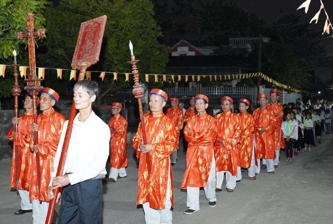 Old people in traditional clothes lead a procession around the village to honor their native martyrs in Xuan Bang parish in Nam Dinh province on Nov. 5