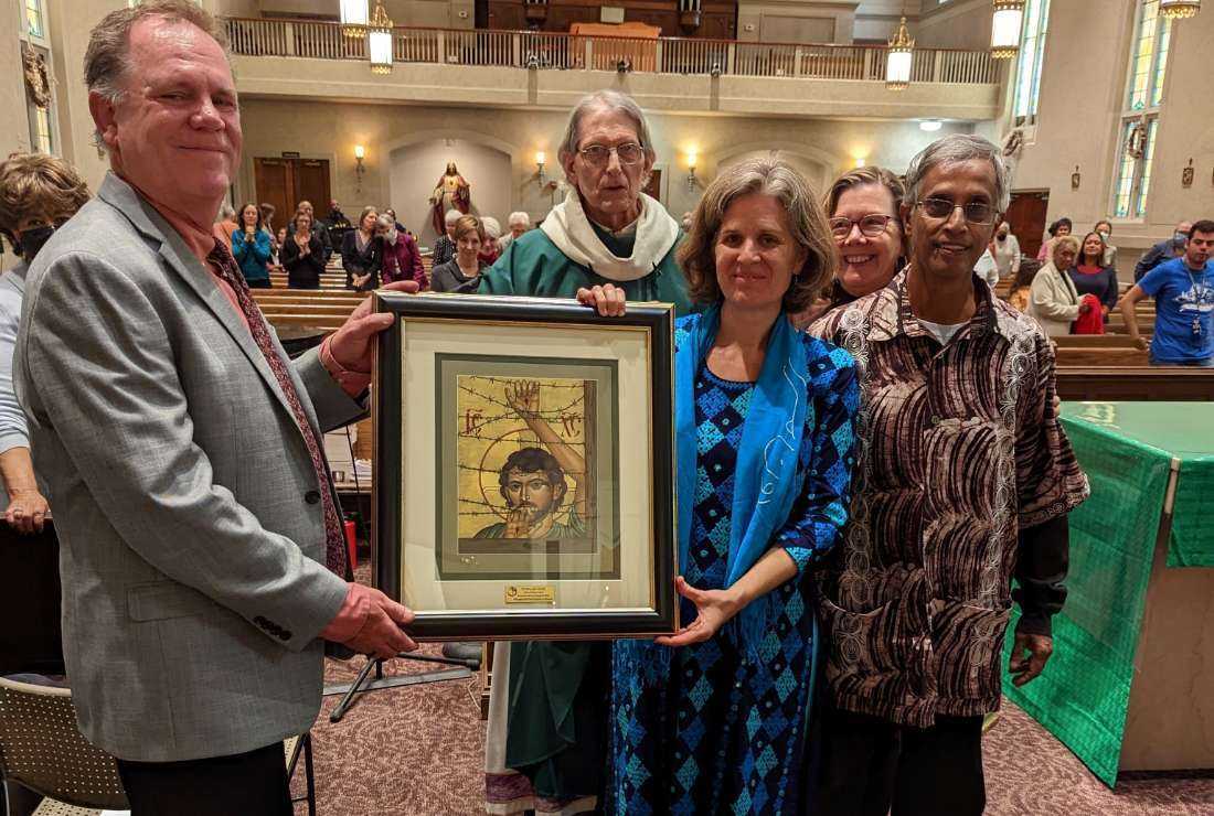 Merwyn and Kirstin De Mello receive the 2022 Bishop McCarthy Spirit of Mission Award from Ted Miles (left) and Mary Novak (second from right) at Holy Redeemer Church in Washington, DC