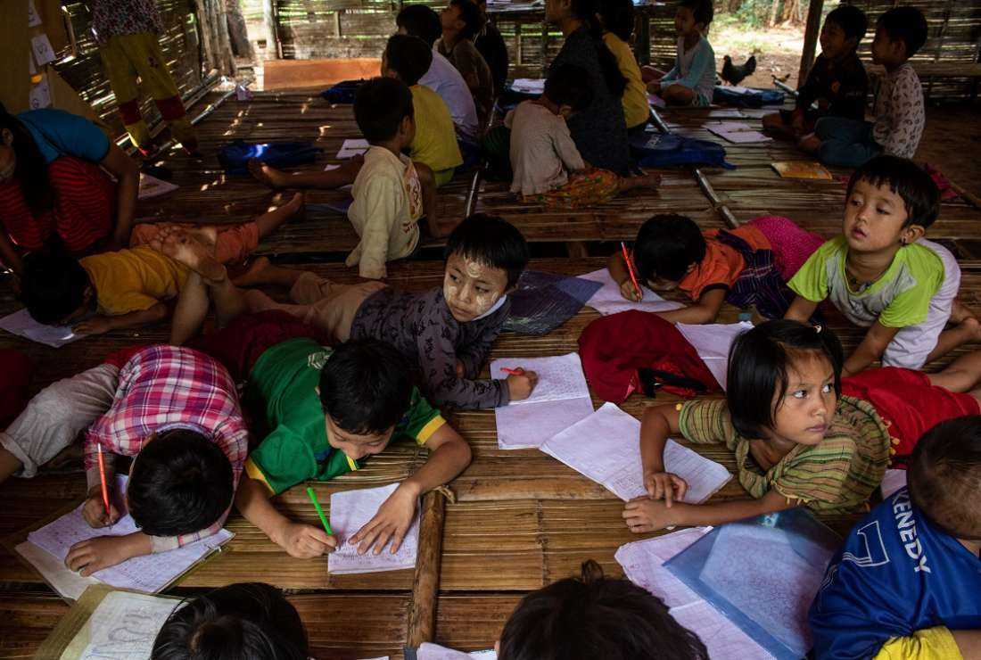 Children attend a class in a temporary shelter at a camp for internally displaced people in Demoso township in Myanmar's Kayah state, Oct. 18, 2021