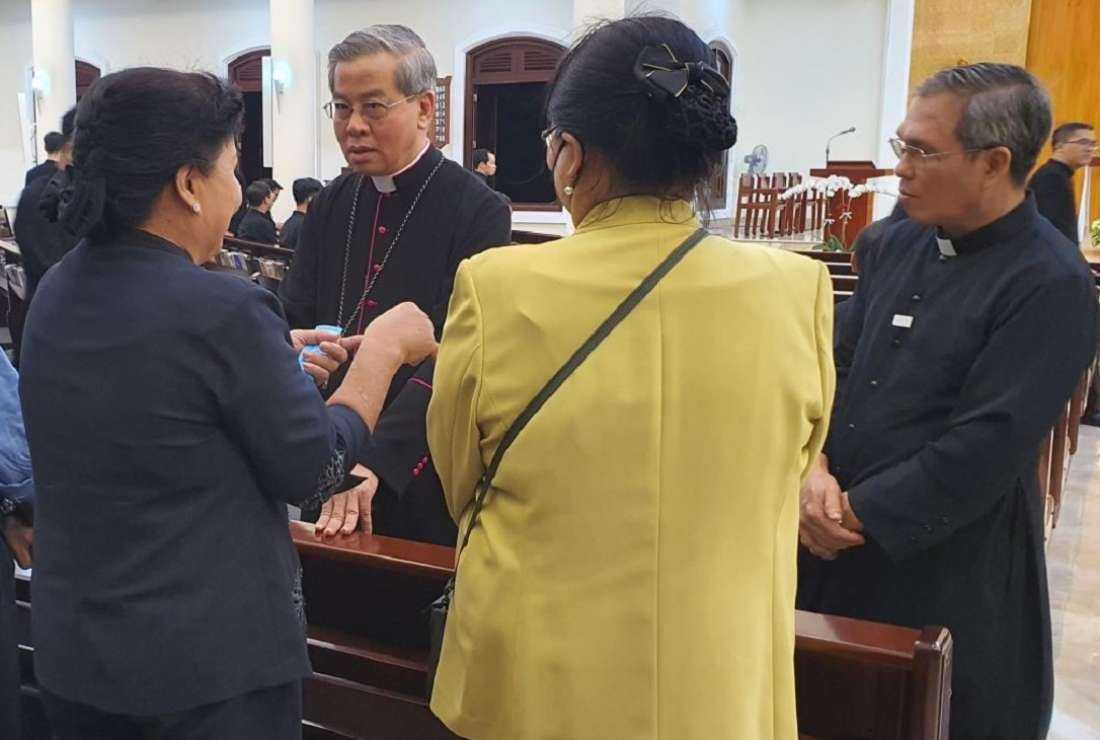 Bishop-elect Joseph Bui Cong Trac (right) and his family talk with Archbishop Joseph Nguyen Nang at St. Joseph Major Seminary of Saigon on Nov. 1