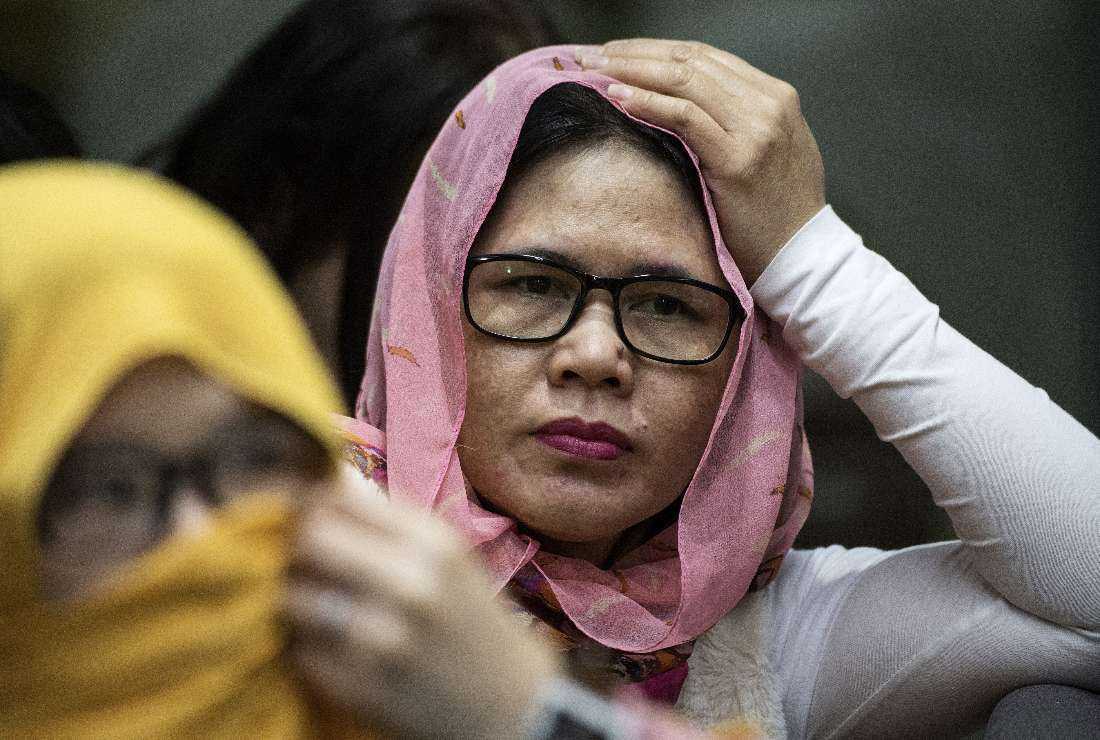 Overseas Filipino workers (OFW) look on after arriving in Manila from Kuwait at Manila International Airport on Feb. 13, 2018