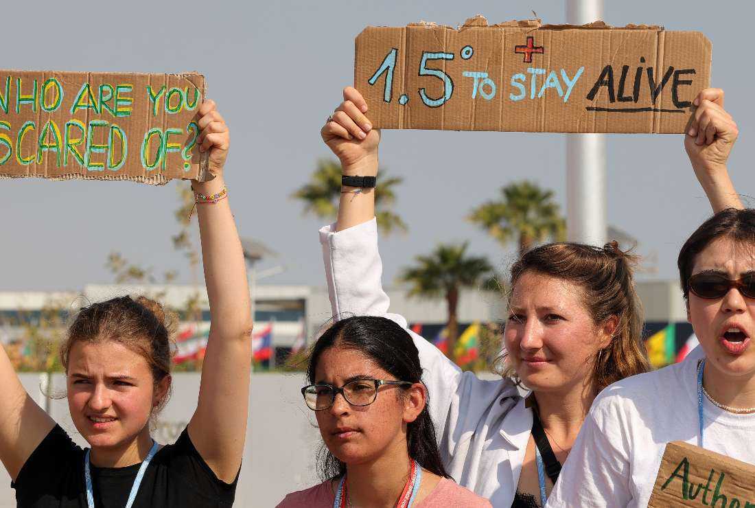 Climate activists gather with signs for a demonstration calling upon the G20 conference to adhere to limit global temperature rise to 1.5 degrees Celsius compared to pre-industrial levels, at the Sharm el-Sheikh International Convention Centre, in Egypt's Red Sea resort city of the same name, during the COP27 climate conference, on Nov. 15