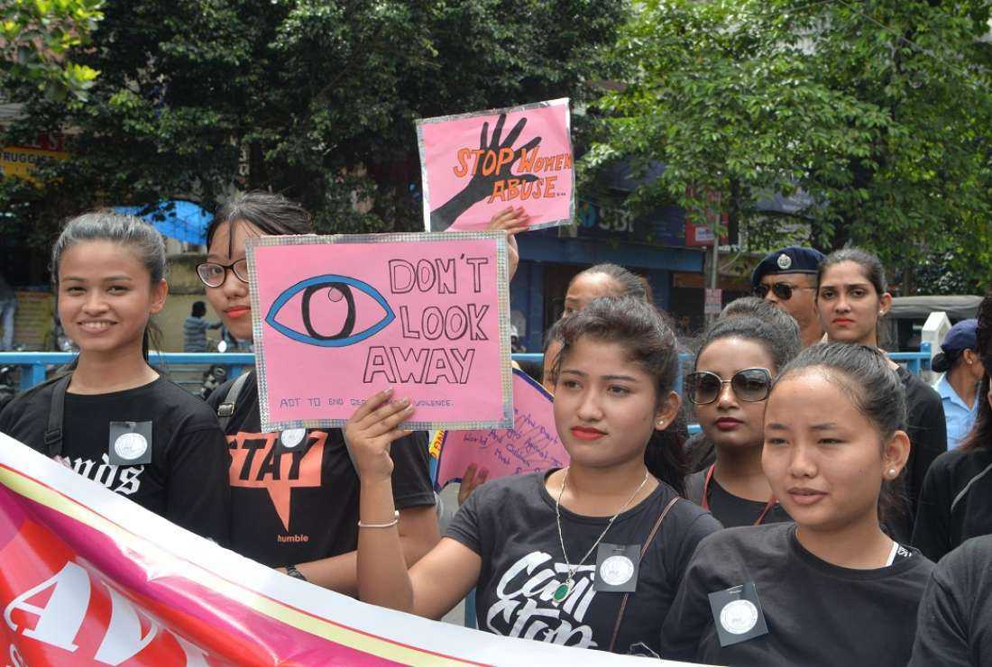 Indian school students and youth hold placards as they participate in an awareness rally against child sex abuse, in Siliguri on July 6, 2019