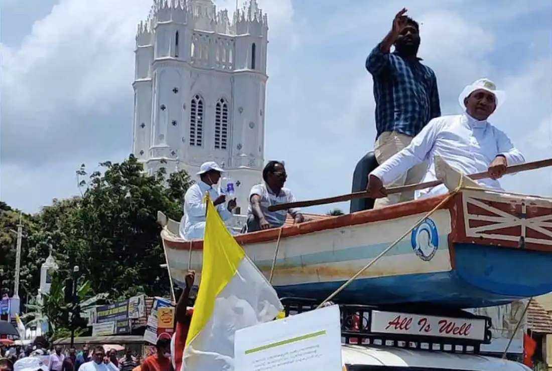 Catholic priests sit on a boat atop a truck as part of a protest in Kerala’s state capital Thiruvananthapuram on Aug. 10 against a multi-billion-dollar port project which they say endangers the livelihoods of thousands of fishermen