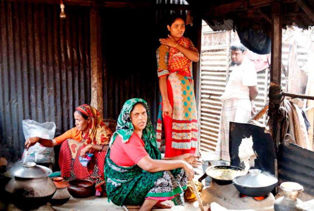 Bangladeshi women are seen cooking inside a makeshift community kitchen in a slum in Dhaka, in this photo taken in 2012