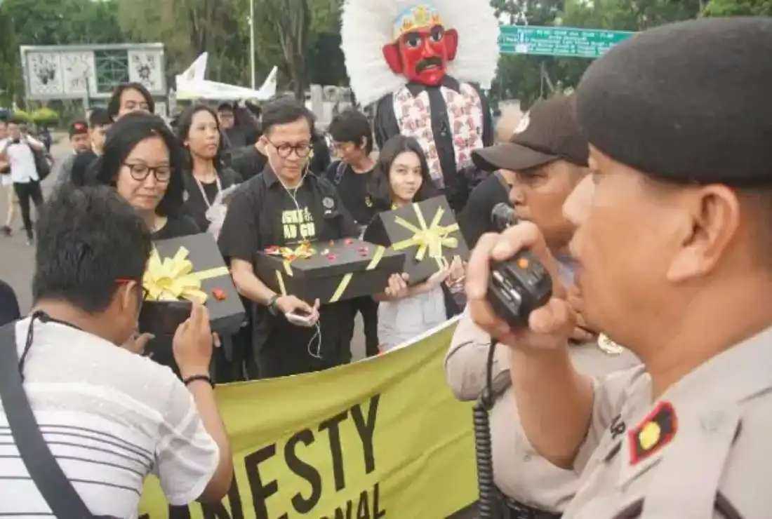 Amnesty International activists mark Human Rights Day by demanding Indonesian President Joko Widodo settle various cases of human rights abuses, including those in Papua, outside the Presidential Palace on Dec. 10, 2019