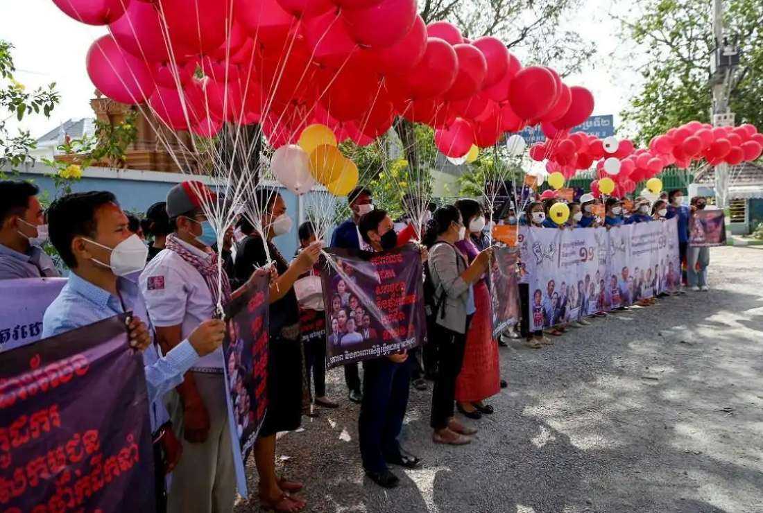 Former employees of NagaWorld casino and rights group representatives prepare to release balloons to mark International Women's Day and to demand the release of jailed trade unionists in front of Prey Sar prison in Phnom Penh on March 8