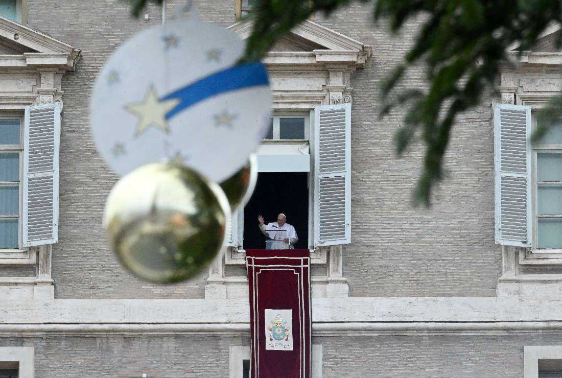 Pope Francis speaks from the window of the apostolic palace overlooking St. Peter's Square during his Angelus prayer at the Vatican on Dec. 4