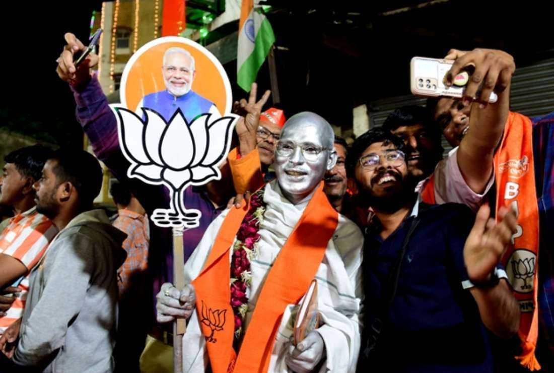 Supporters of India's ruling Bharatiya Janata Party cheer for Prime Minister Narendra Modi after a landslide in his home state Gujarat during a victory rally in Ahmedabad on Dec. 8