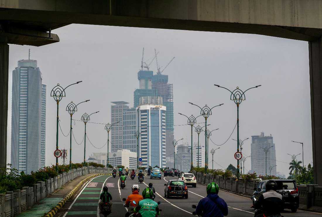 Motorists commute during the morning rush hour in Jakarta on Dec. 7