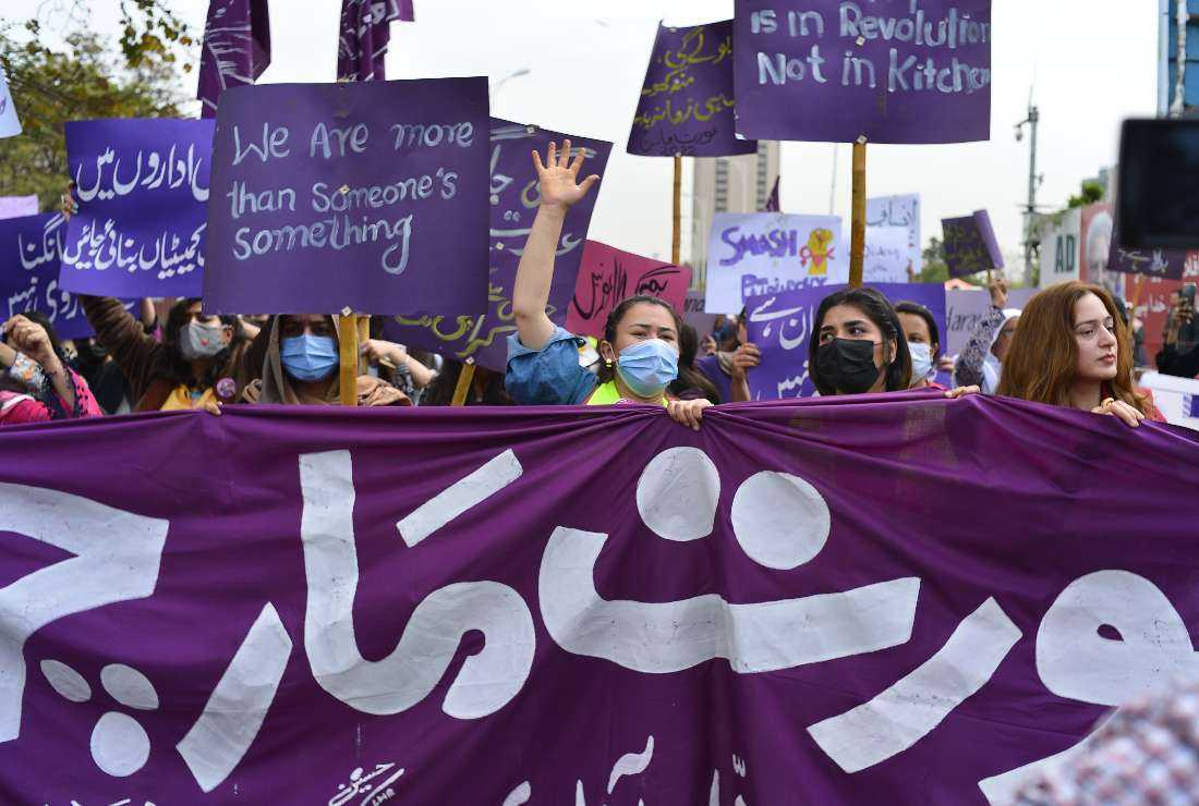 Aurat March protesters hold placards and shout slogans as they gather to mark the International Women's Day in Islamabad on March 8