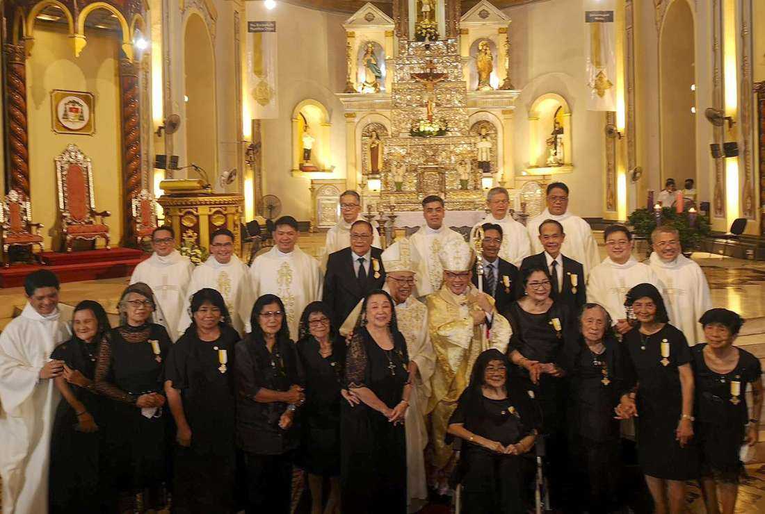 Archbishop Gilbert Garcera of Lipa Archdiocese in the Philippines pose for a photo with 14 laypeople who received a prestigious papal award on Dec. 7