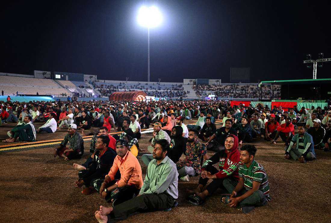 Qatar's migrant workers watch a match during the Qatar 2022 World Cup at the Asian Town cricket stadium, on the outskirts of Doha, on Dec. 6