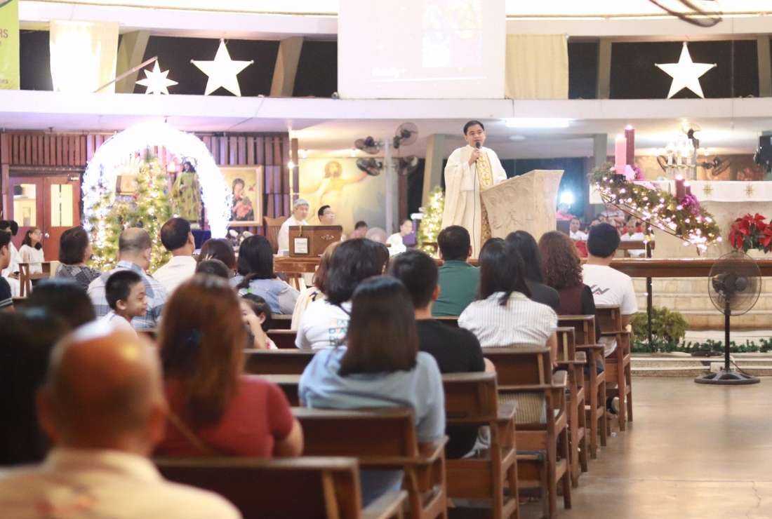 Catholic devotees attend a dawn Mass at the Church of the Holy Sacrifice in Quezon City of Manila in 2019