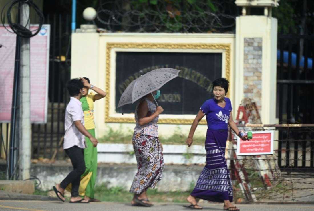 People walk outside Insein prison in Yangon on November 17, 2022