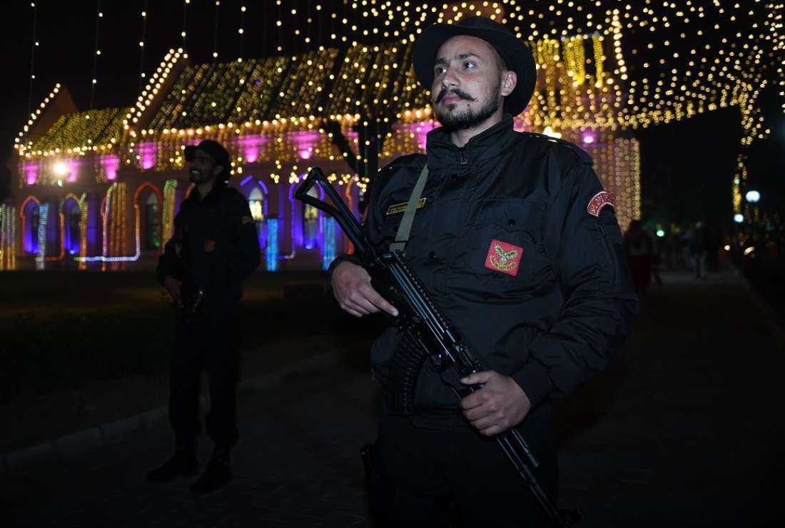 Police commandos stand guard outside the illuminated St Paul's church on the eve of Christmas in Amritsar on Dec. 24, 2021. Indian Christians in the southern Indian state of Karnataka have called for police protection to ensure a peaceful Christmas as Christians say they are reeling under attacks from Hindus since the enactment of an anti-conversion law