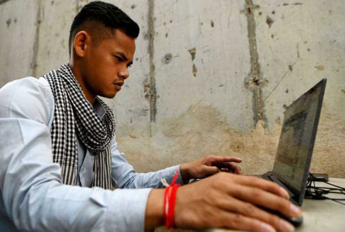 This photo taken on Jan. 29, 2022, shows hip-hop artist Kea Sokun listening to one of his songs online at a cafe in Phnom Penh. Kea Sokun, whose lyrics about injustice and corruption have struck a chord with Cambodia's disaffected youth, was among those jailed in recent years in the latest move by authorities to clamp down on dissent