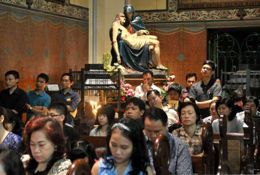 Christians in Indonesia attend a prayer service at a Catholic church in Jakarta on April 18, 2014